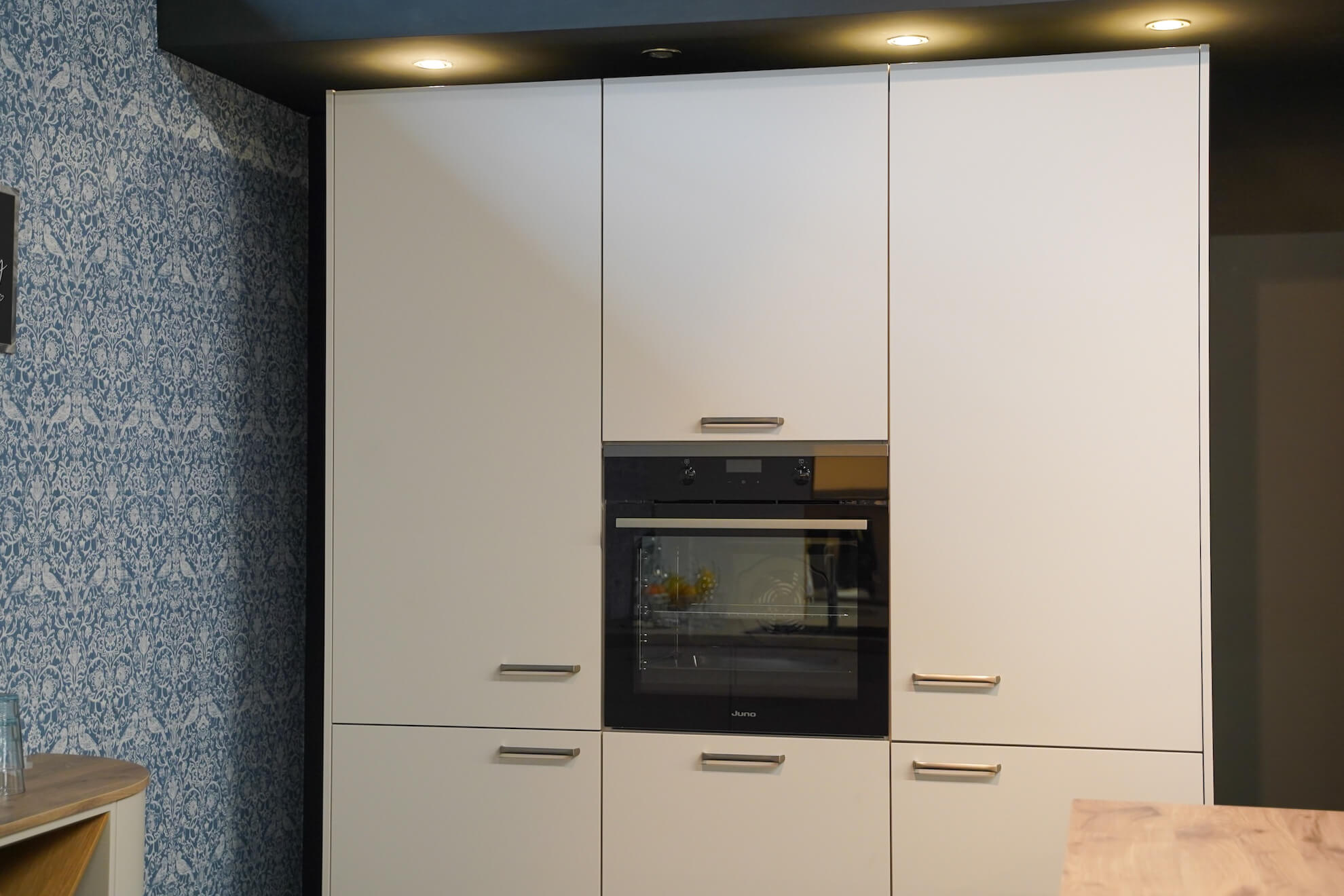 Musterkueche Schueller moderne L-Kueche mit Hochschrank